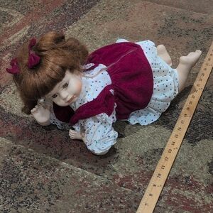 Plush-Accented Porcelain Baby Doll in Maroon Dress